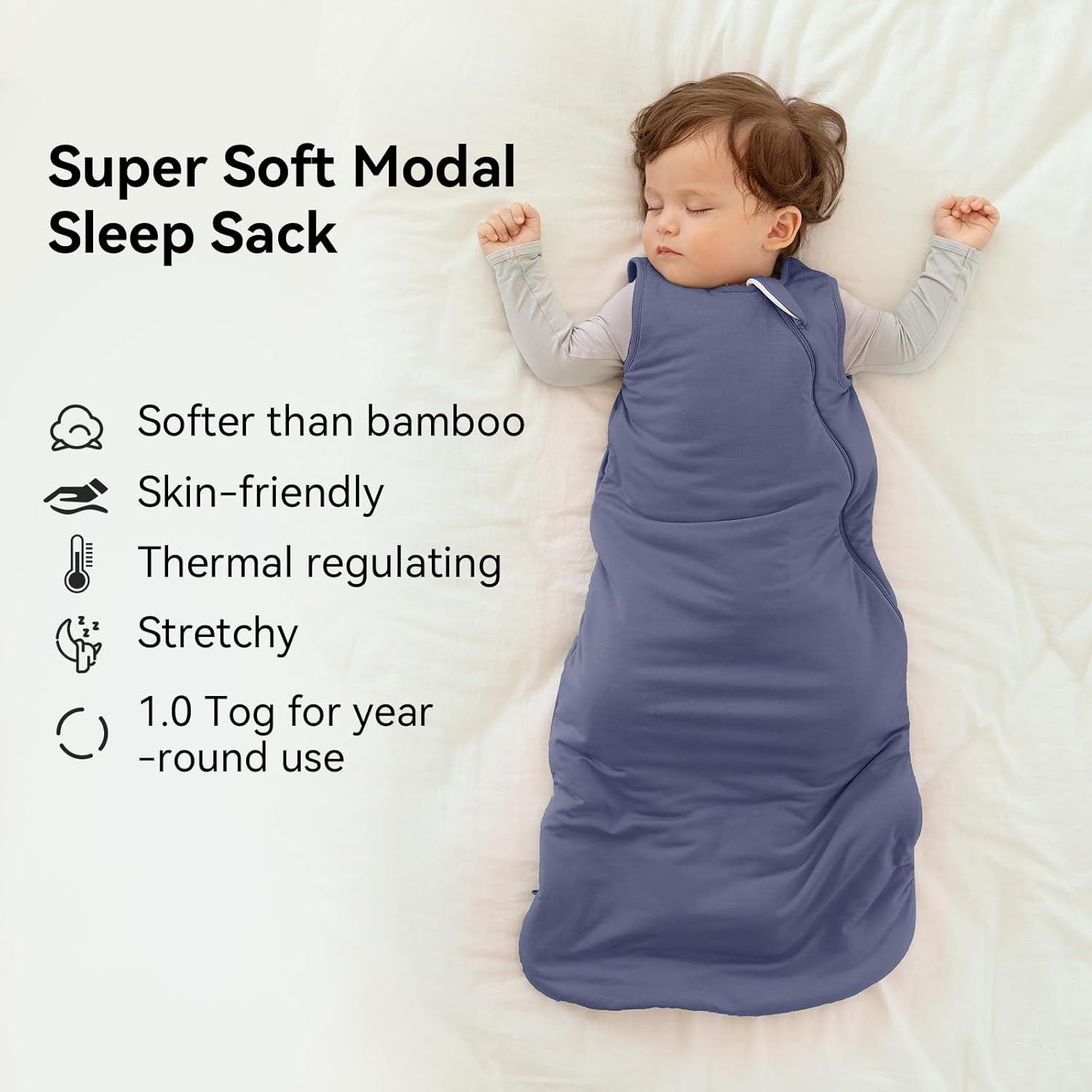 Peaceful baby sleeping in a BubblePanda Navy Silky Modal sleep sack showing its buttery-soft and breathable fabric texture